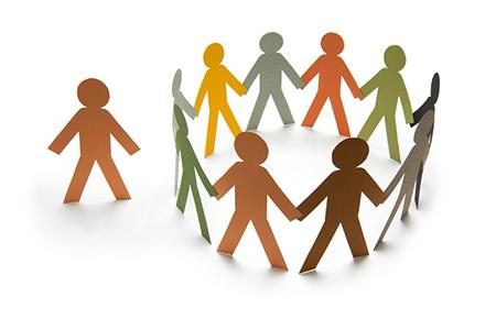 a circle of paper people of different colors holding hands with 一个 unattached paper person on the outside of the circle.